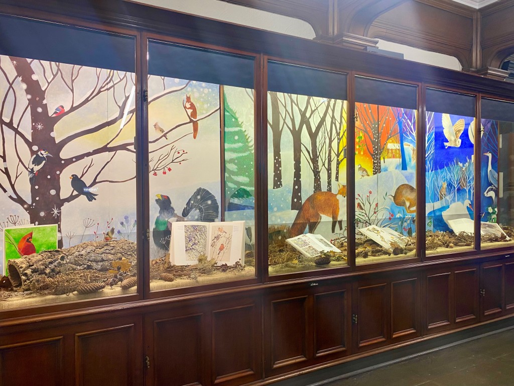 A view of the Winter exhibition displayed in wooden glass cabinets.