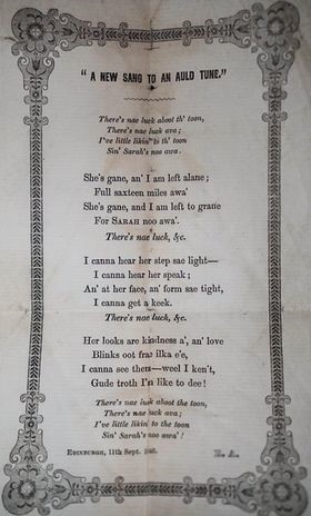 A printed poem is surrounded by an ornate page border. 