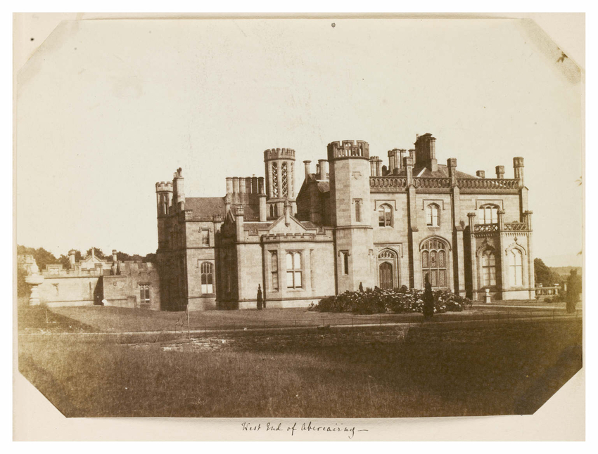 A view of a turreted and ornate large stately home.