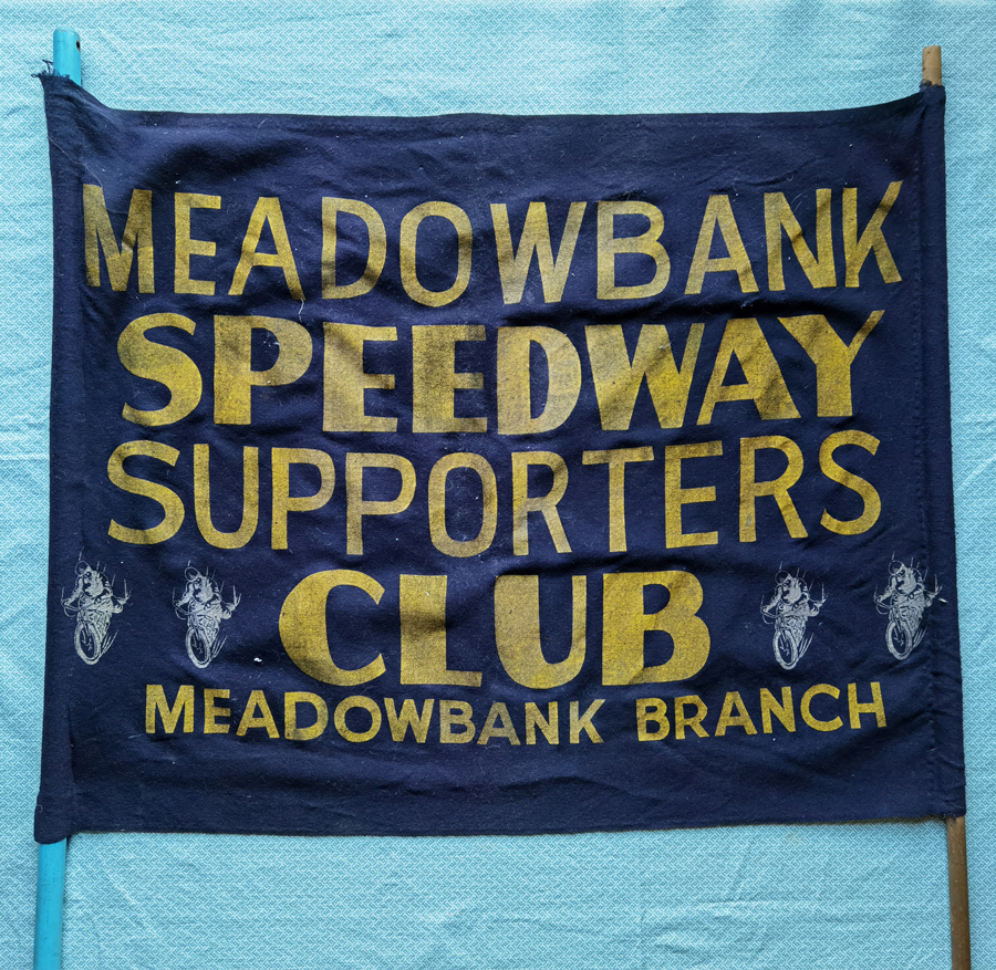 A large navy sign for the "Meadowbank Speedway Supporters Club, Meadowbank Branch" is pictured against a light blue background.